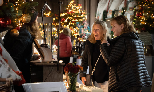 Visitors enjoying the Mercatum Christmas Artisan Market at HaddonHall, browsing handmade gifts and festive decorations.